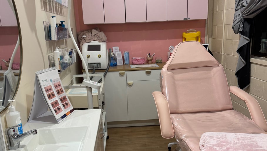 Luxury treatment room at Maddi's Cosmetic Clinique, Melbourne, Victoria, AU with pink accents and sleek decor.