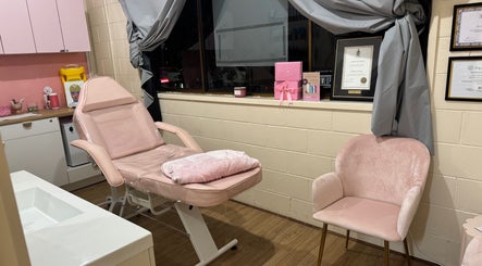 Treatment room at Maddi's Cosmetic Clinique, Melbourne, Victoria, AU with pink chair and decor.
