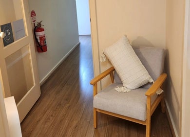 Inviting seating area at Maddi's Cosmetic Clinique, Melbourne, Victoria, AU with a soft chair and cushion.