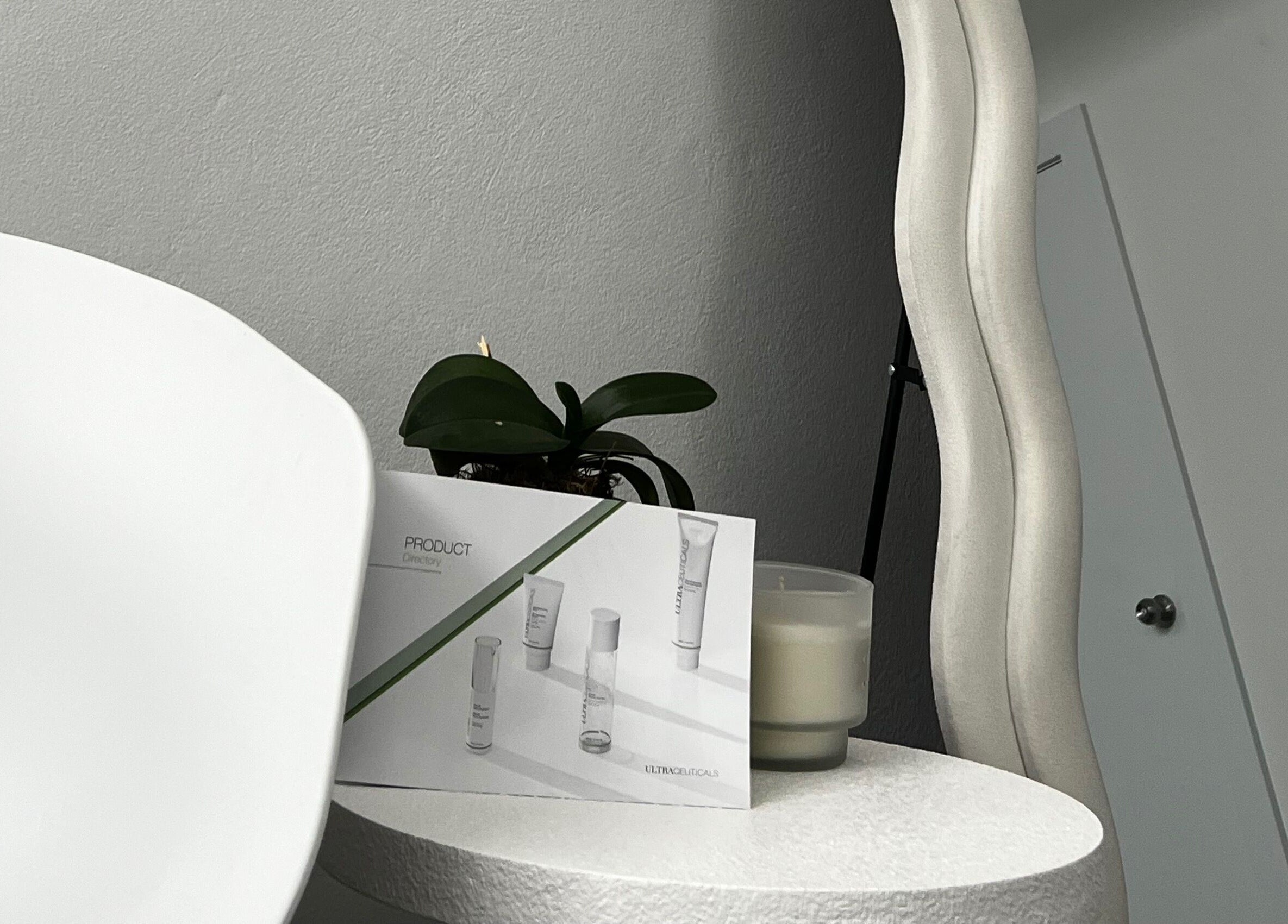 Modern skincare setup at Skin in Balance, Belmore, New South Wales, AU with products and a wavy mirror.