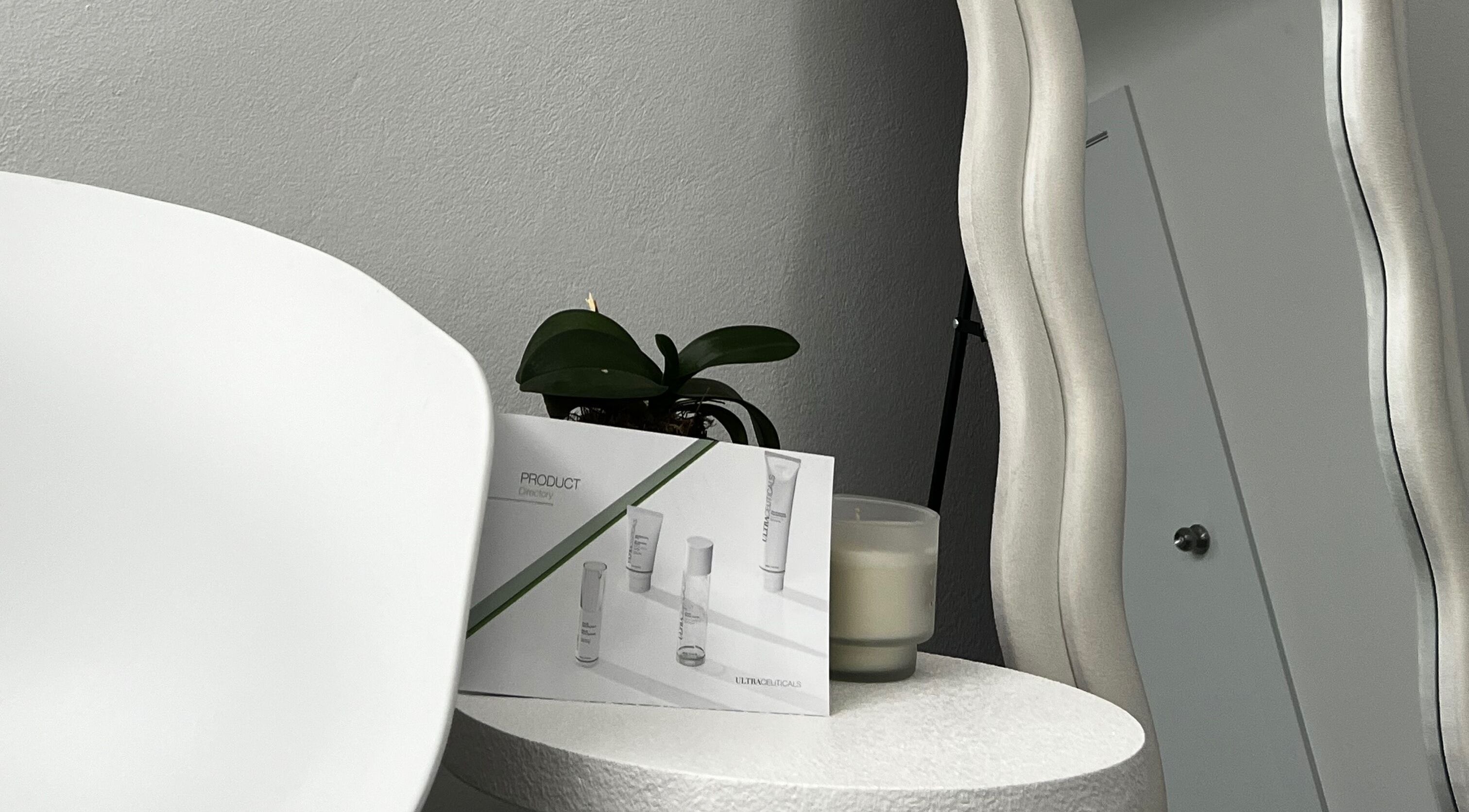 Modern skincare setup at Skin in Balance, Belmore, New South Wales, AU with products and a wavy mirror.