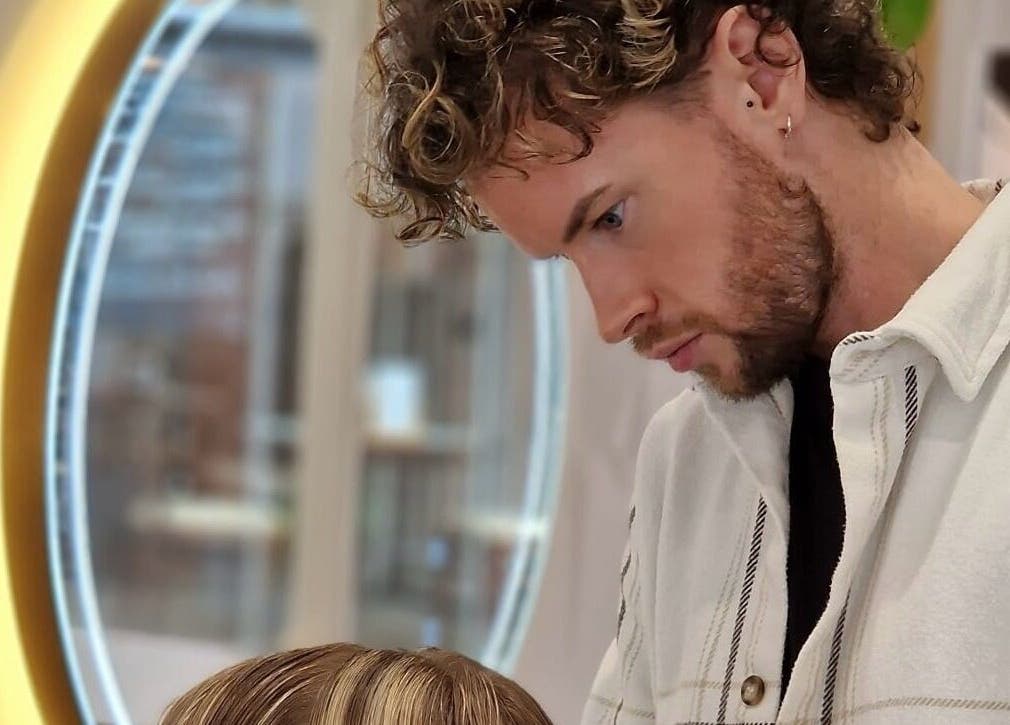 Stylist at HAIR By Joshua Jones in Taunton, England, GB, giving a haircut in a modern salon setting.