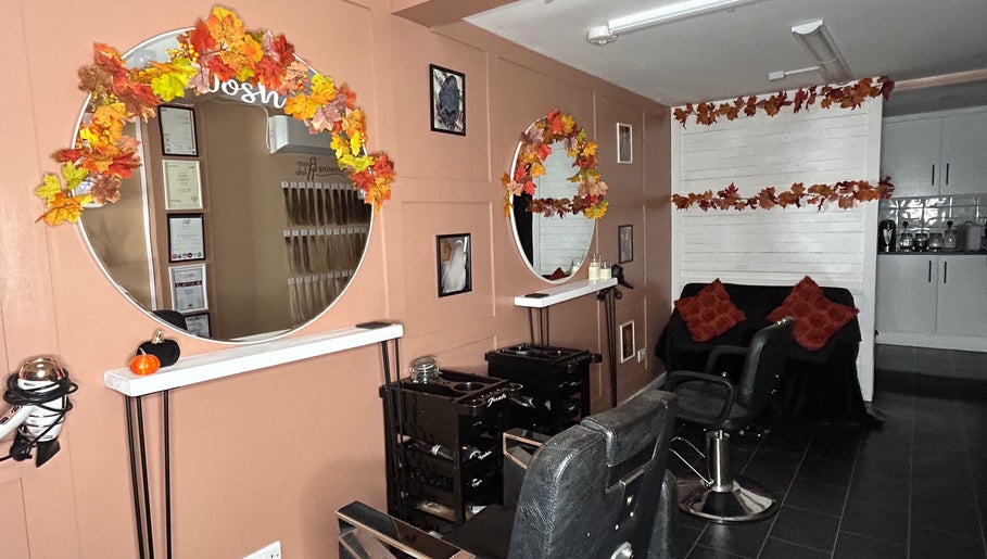 Cozy interior of Josh’s Hair Hideaway in Leicester, England, with autumn décor and styling chairs.