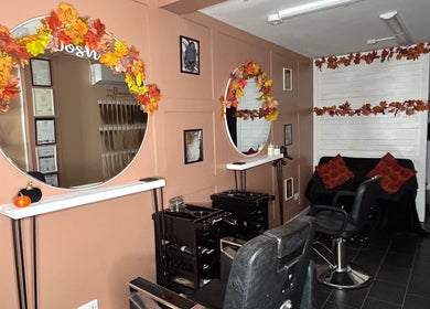 Cozy interior of Josh’s Hair Hideaway in Leicester, England, with autumn décor and styling chairs.
