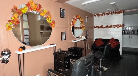 Cozy interior of Josh’s Hair Hideaway in Leicester, England, with autumn décor and styling chairs.