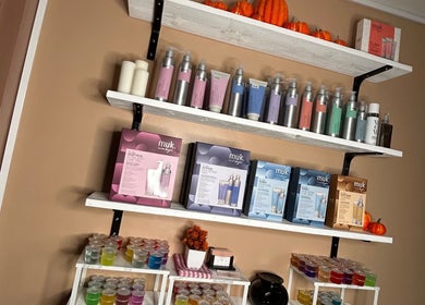 Product display shelves at Josh’s Hair Hideaway, Leicester, England, GB featuring Muk haircare products.