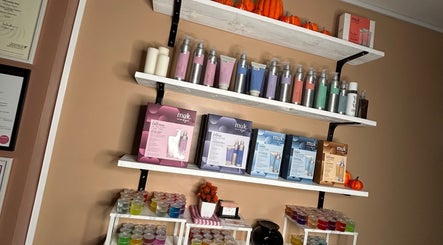 Product display shelves at Josh’s Hair Hideaway, Leicester, England, GB featuring Muk haircare products.