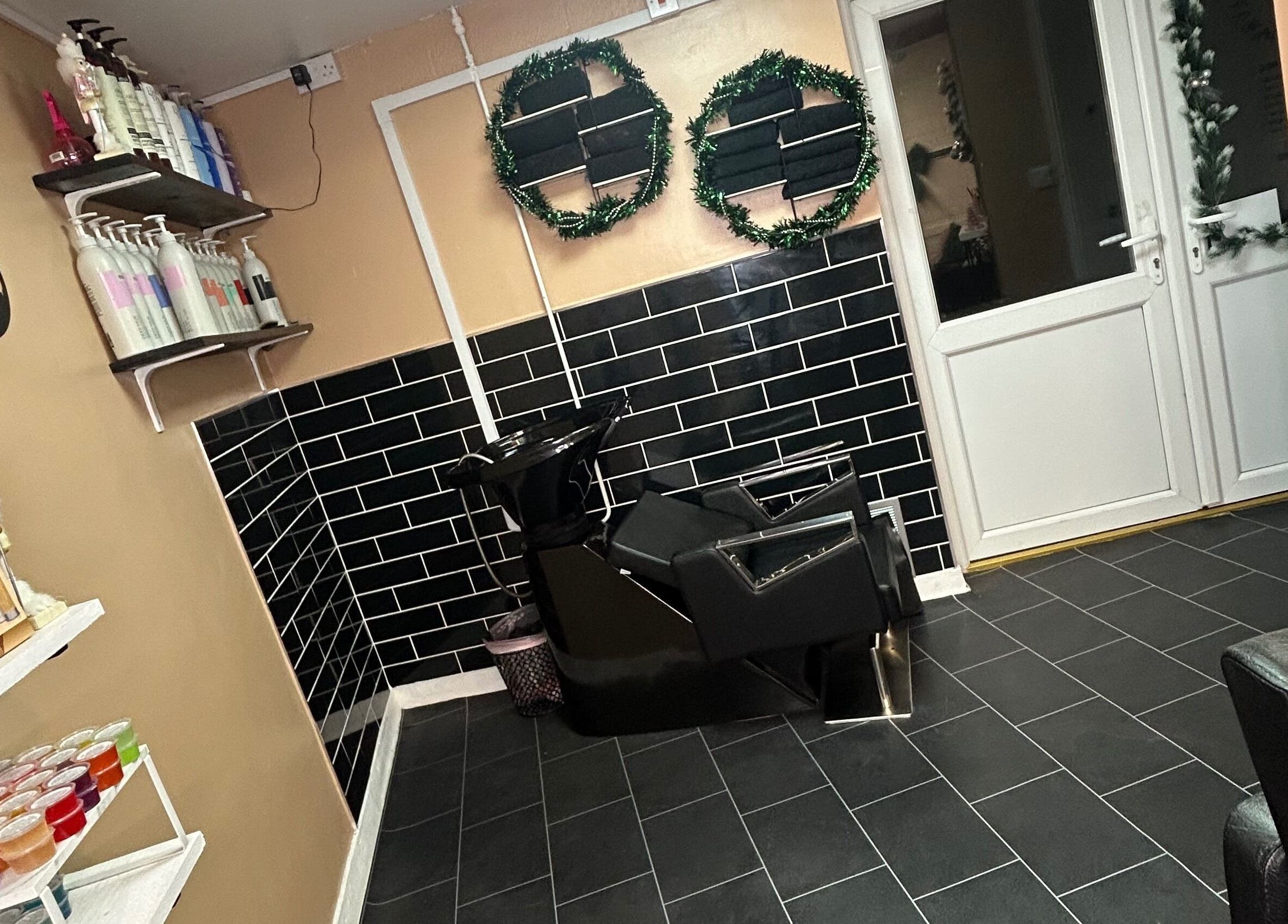 Salon interior at Josh’s Hair Hideaway, Leicester, England, featuring a sleek wash station and stylish shelves.