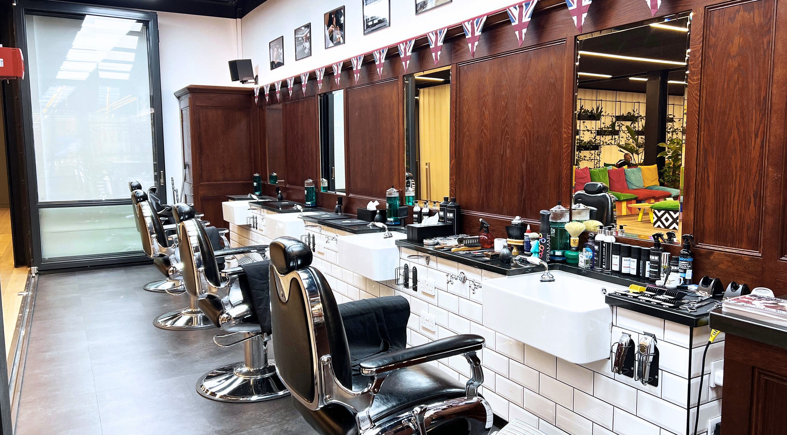 Elegant barber chairs at Pall Mall Barbers Liverpool Street, London, England, GB, showcasing modern grooming ambiance.