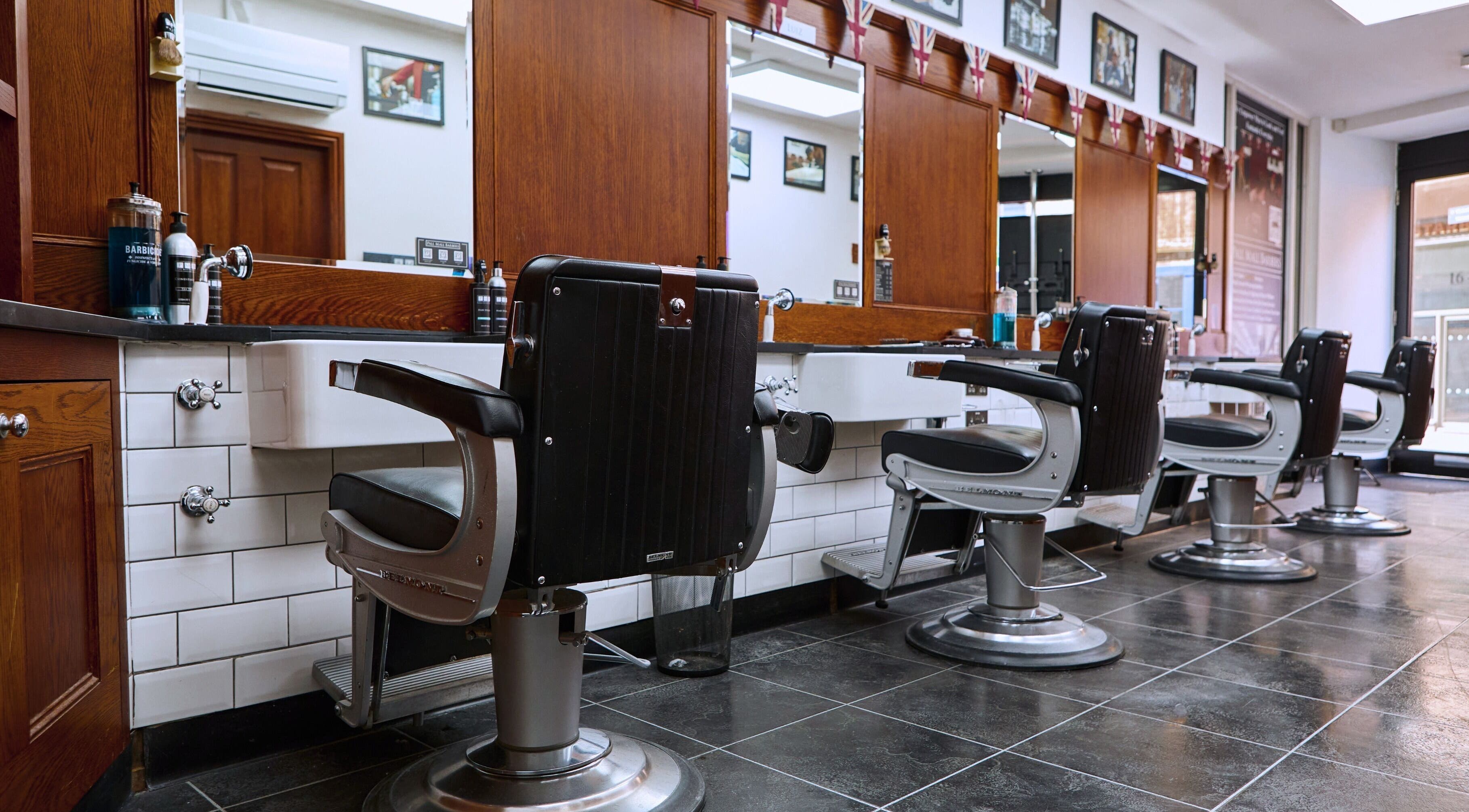 Interior of Pall Mall Barbers Westminster in London, England, GB showcasing traditional chairs and elegant decor.