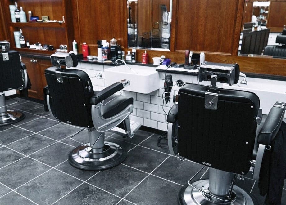 Elegant barber chairs at Pall Mall Barbers Kings Cross, London, England, GB, set against a classic interior.