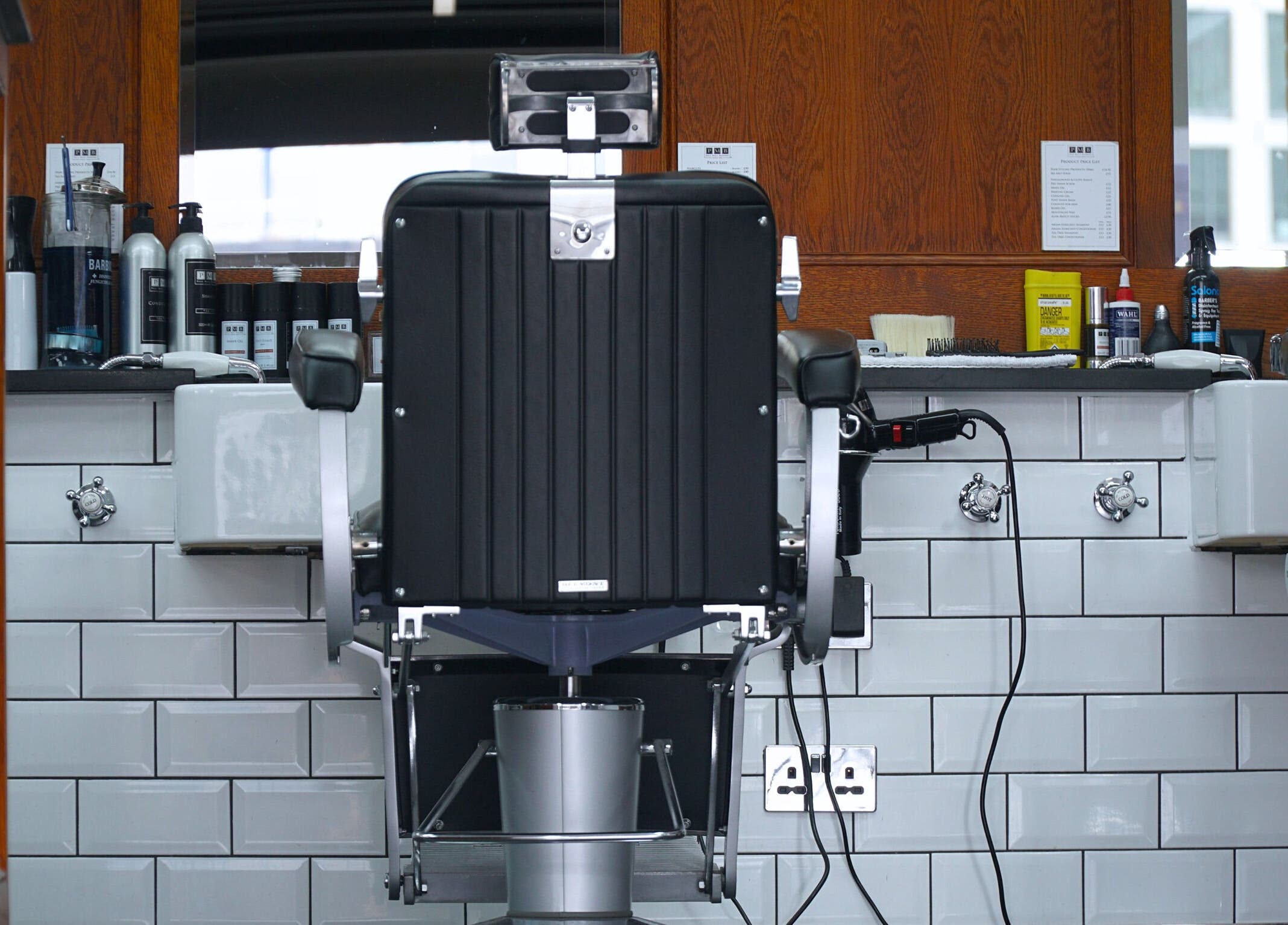Modern barber chair and grooming products at Pall Mall Barbers Kings Cross in London, England, GB.