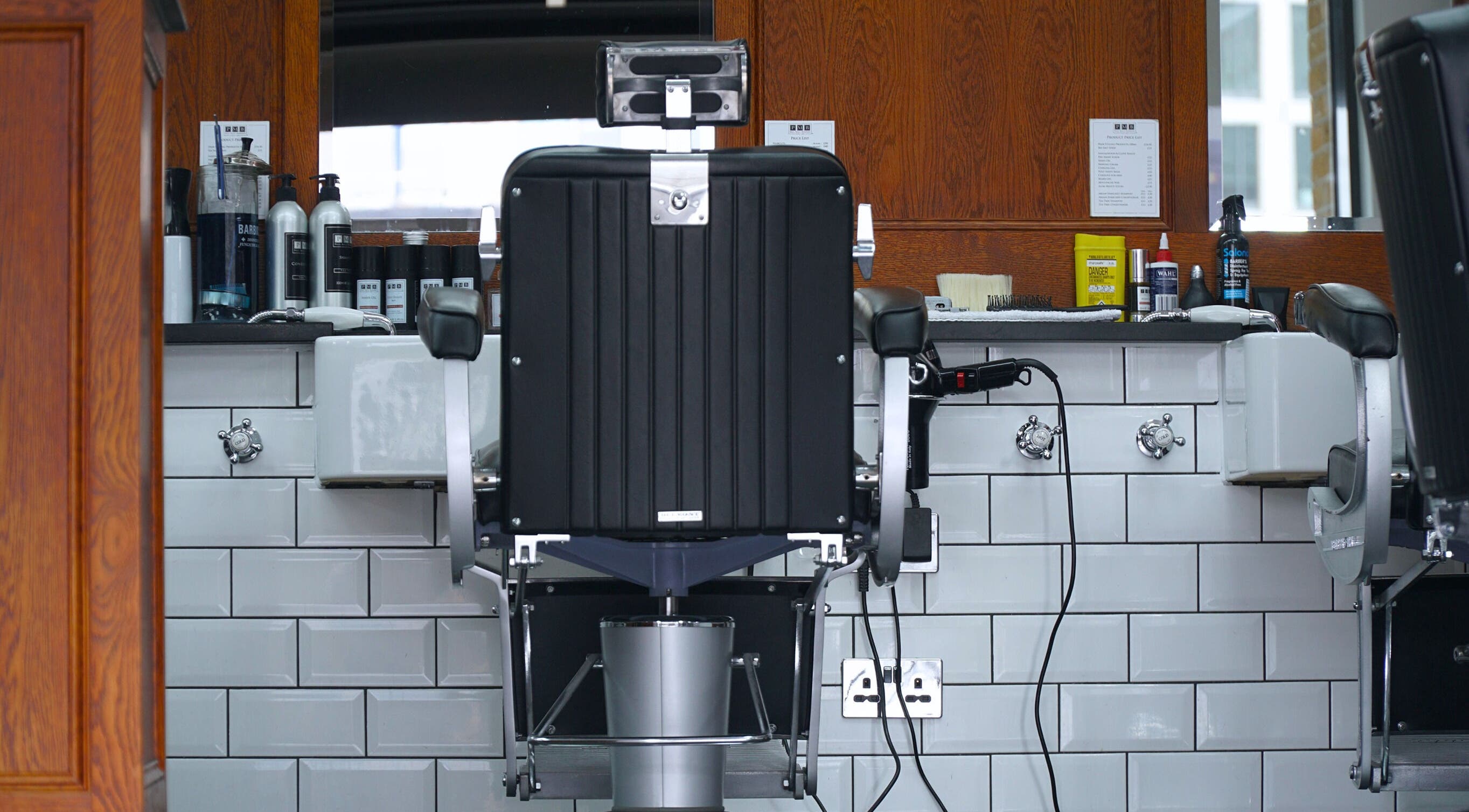 Modern barber chair and grooming products at Pall Mall Barbers Kings Cross in London, England, GB.