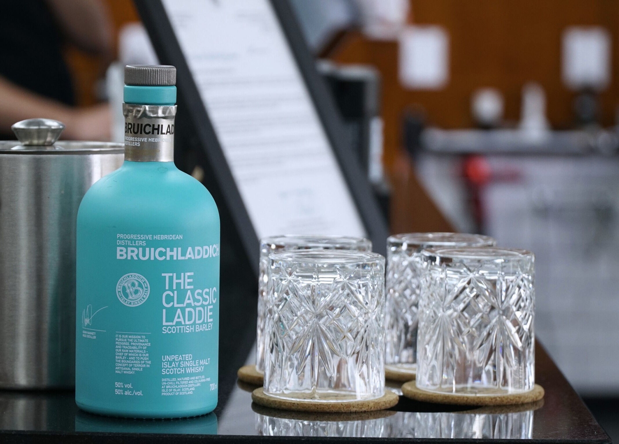 A refined bar setup with whisky and glasses at Pall Mall Barbers Kings Cross, London, England, GB.
