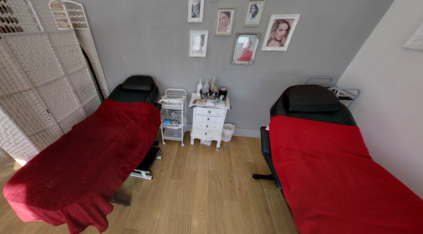 Cozy treatment room at Pure Beauty in Broughton Astley, England with massage tables and decor.