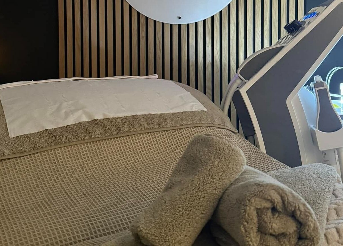 Relaxing spa bed with warm towels at The Beauté Spot, Ampthill, England, GB, featuring modern beauty equipment.