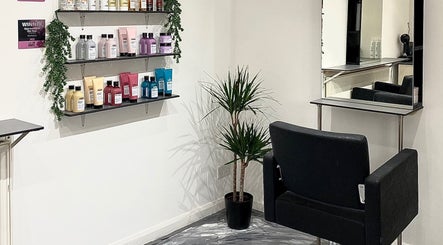 Hair product shelves and styling chair at Eclipse Hair Salon, Houghton Regis, England, GB.