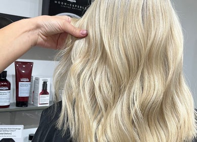 Blonde hair styled with loose waves at Eclipse Hair Salon, Houghton Regis, England, GB.