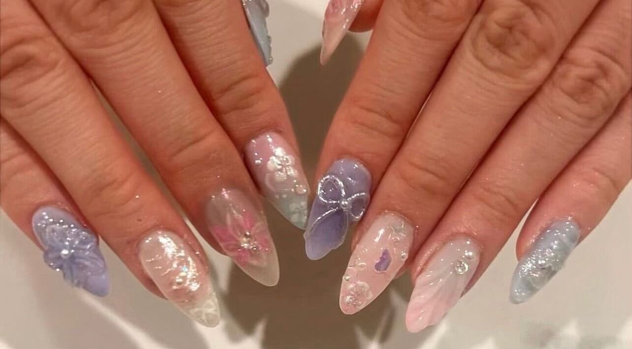 Elegant pastel nail art at Nails By Hineni in Brambleton, Virginia, US featuring intricate designs.