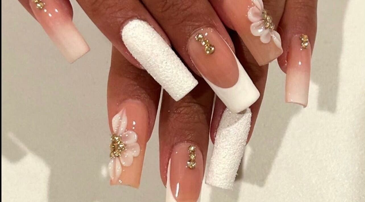 Beautiful floral nail art with rhinestones at Nails By Hineni, Brambleton, Virginia, US.