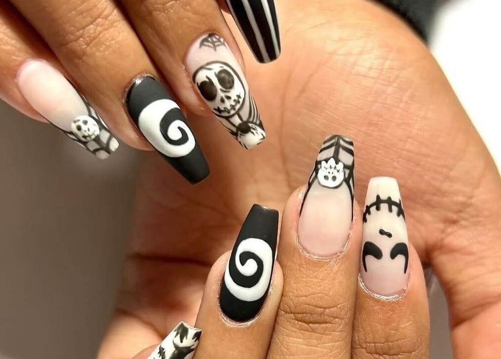 Halloween-themed nail art at Nails By Hineni, Brambleton, Virginia, US. Spooky and stylish designs in black and white.