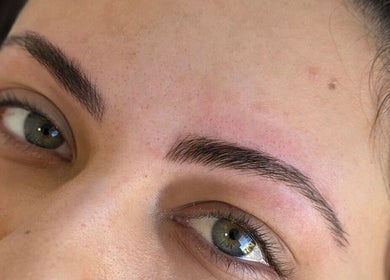 Freshly shaped eyebrows at Blade It Babe in South Surrey, British Columbia, CA, showcasing expert grooming.