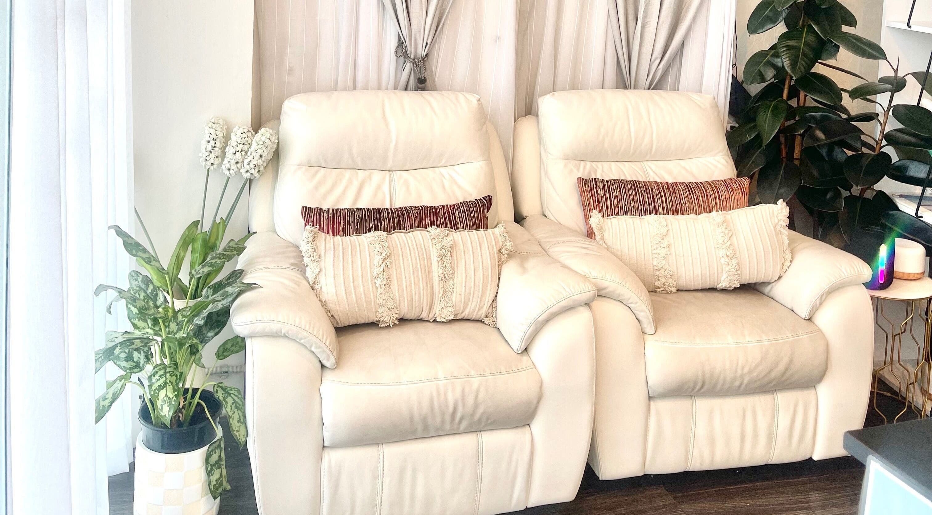 Cozy seating at Amari Thai Massage in Richmond, Victoria, AU, with plush chairs and greenery.