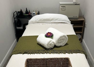 Peaceful massage room at Nalin Thai Massage Therapy, Derby, England, GB with neatly arranged towels and calming decor.