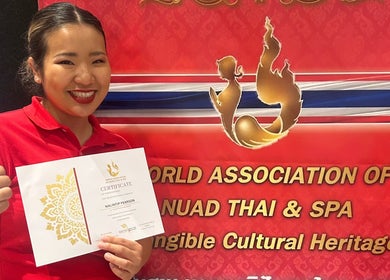 Proud recipient at Nalin Thai Massage Therapy in Derby, England celebrating an award of excellence.
