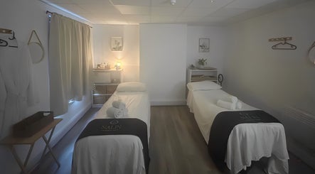 Tranquil massage room at Nalin Thai Massage Therapy in Derby, England, GB, featuring two cozy tables.