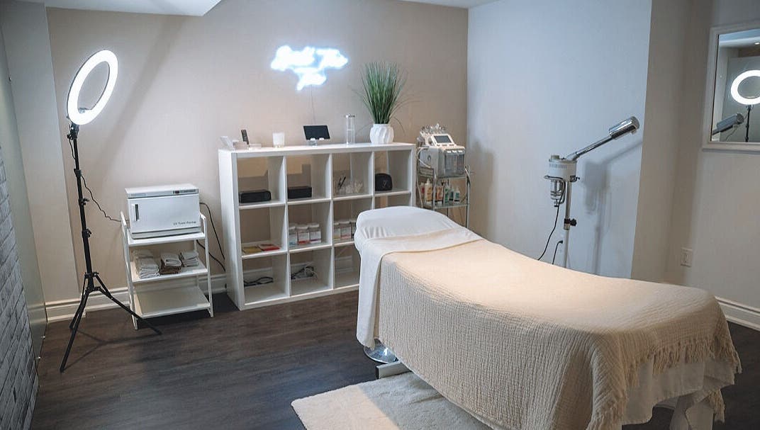Elegant spa treatment room at Glow FX, Barrie, Ontario, CA, featuring a comfortable massage bed and modern decor.