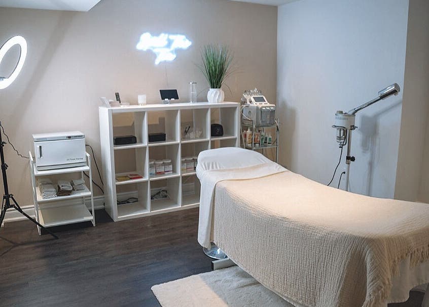 Elegant spa treatment room at Glow FX, Barrie, Ontario, CA, featuring a comfortable massage bed and modern decor.