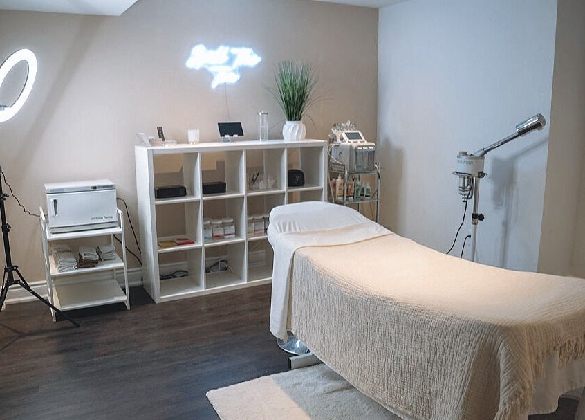Elegant spa treatment room at Glow FX, Barrie, Ontario, CA, featuring a comfortable massage bed and modern decor.