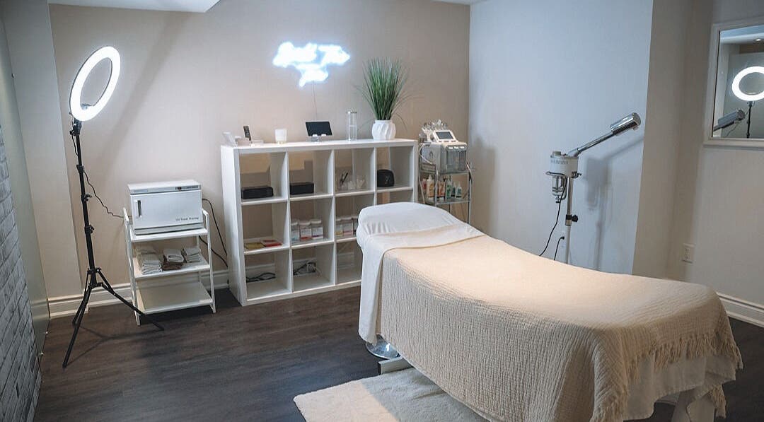 Elegant spa treatment room at Glow FX, Barrie, Ontario, CA, featuring a comfortable massage bed and modern decor.