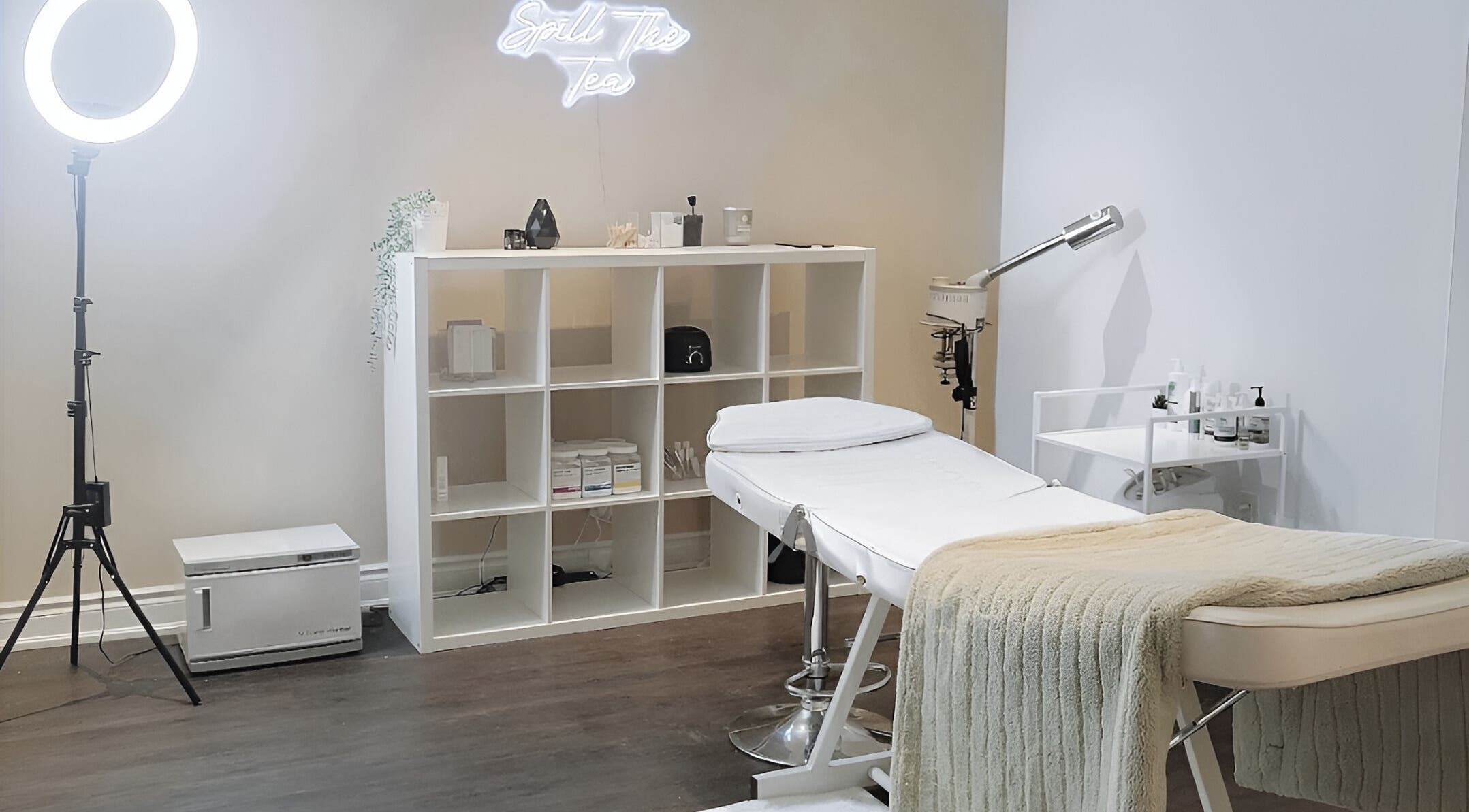 Relaxing treatment room at Glow FX, Barrie, Ontario, CA, featuring a plush bed and calming decor.