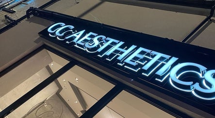 Illuminated sign of Hair by Maddie B at Marple, England, GB enhancing the chic entrance.