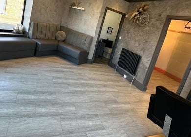 Spacious, modern interior at Hair by Maddie B, Marple, England, GB with sleek seating and elegant decor.