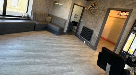 Spacious, modern interior at Hair by Maddie B, Marple, England, GB with sleek seating and elegant decor.