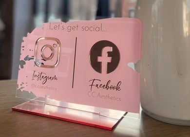 Pink social media sign at Hair by Maddie B, Marple, England, GB with Instagram and Facebook icons.