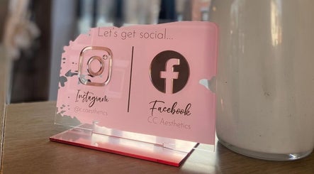 Pink social media sign at Hair by Maddie B, Marple, England, GB with Instagram and Facebook icons.