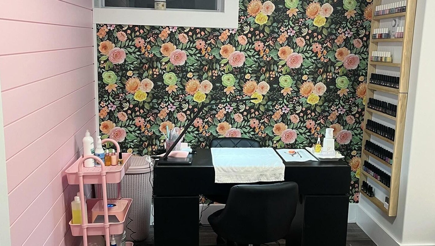 Chic nail salon interior at Nail Design by Megan, Fenelon Falls, Ontario, CA with floral wall and manicure station.