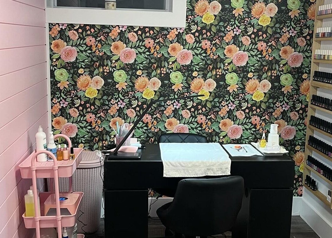 Chic nail salon interior at Nail Design by Megan, Fenelon Falls, Ontario, CA with floral wall and manicure station.