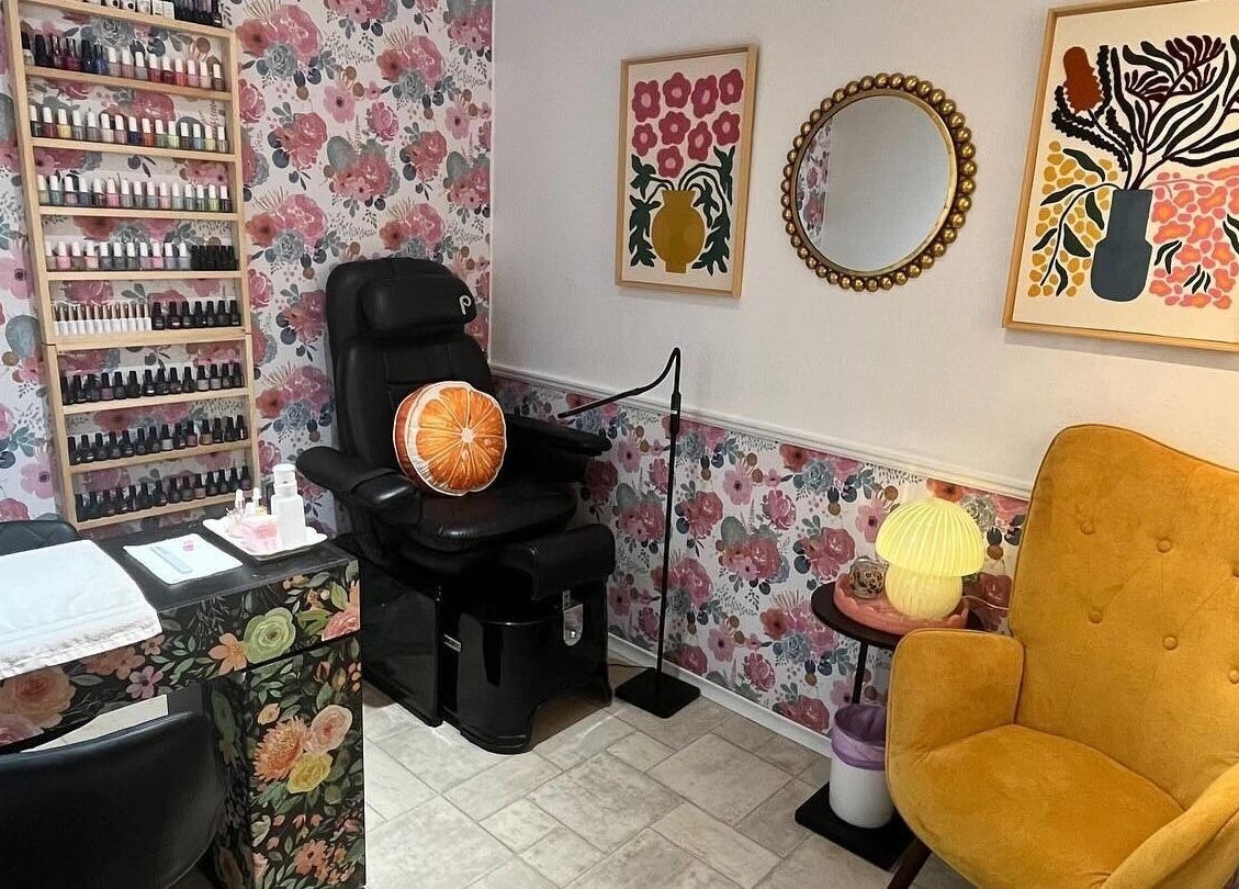 Chic nail studio in Fenelon Falls, Ontario, CA at Nail Design by Megan, featuring floral decor and cozy chairs.