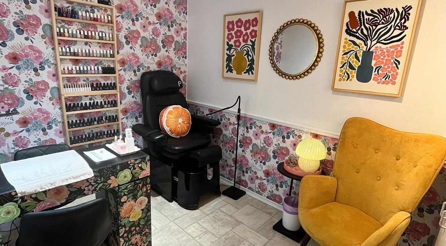 Chic nail studio in Fenelon Falls, Ontario, CA at Nail Design by Megan, featuring floral decor and cozy chairs.