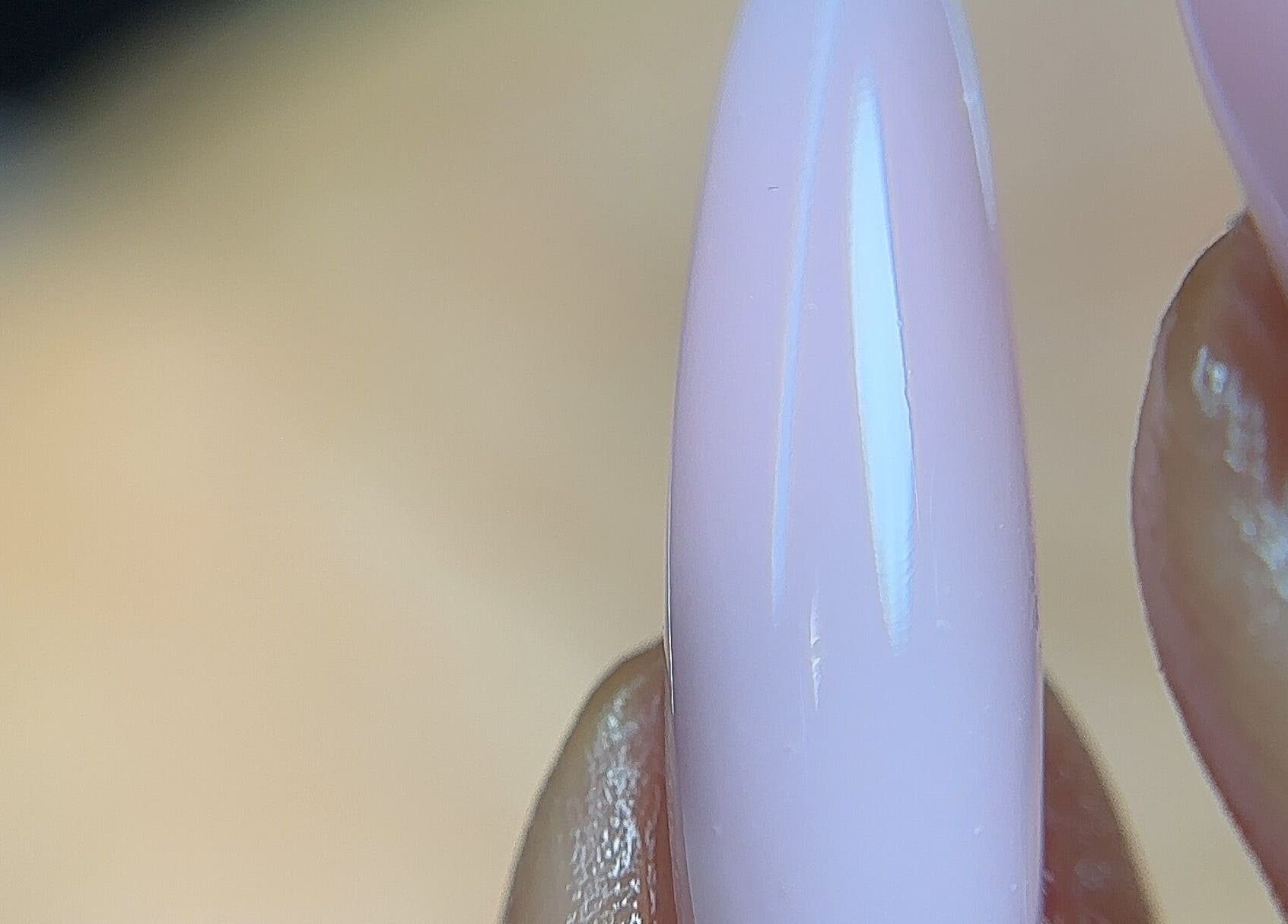 Close-up of polished nail at Nailglams ng, Abule Egba, Lagos, NG. Showcases expert manicure technique.