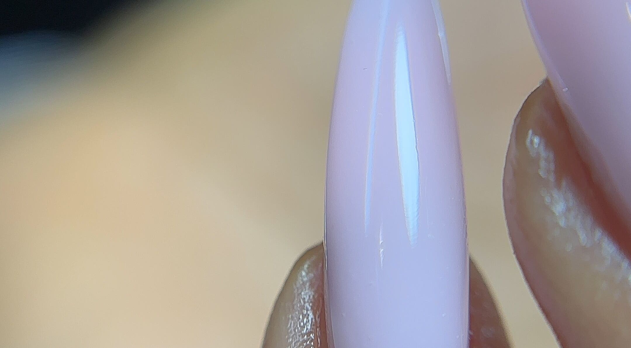 Close-up of polished nail at Nailglams ng, Abule Egba, Lagos, NG. Showcases expert manicure technique.