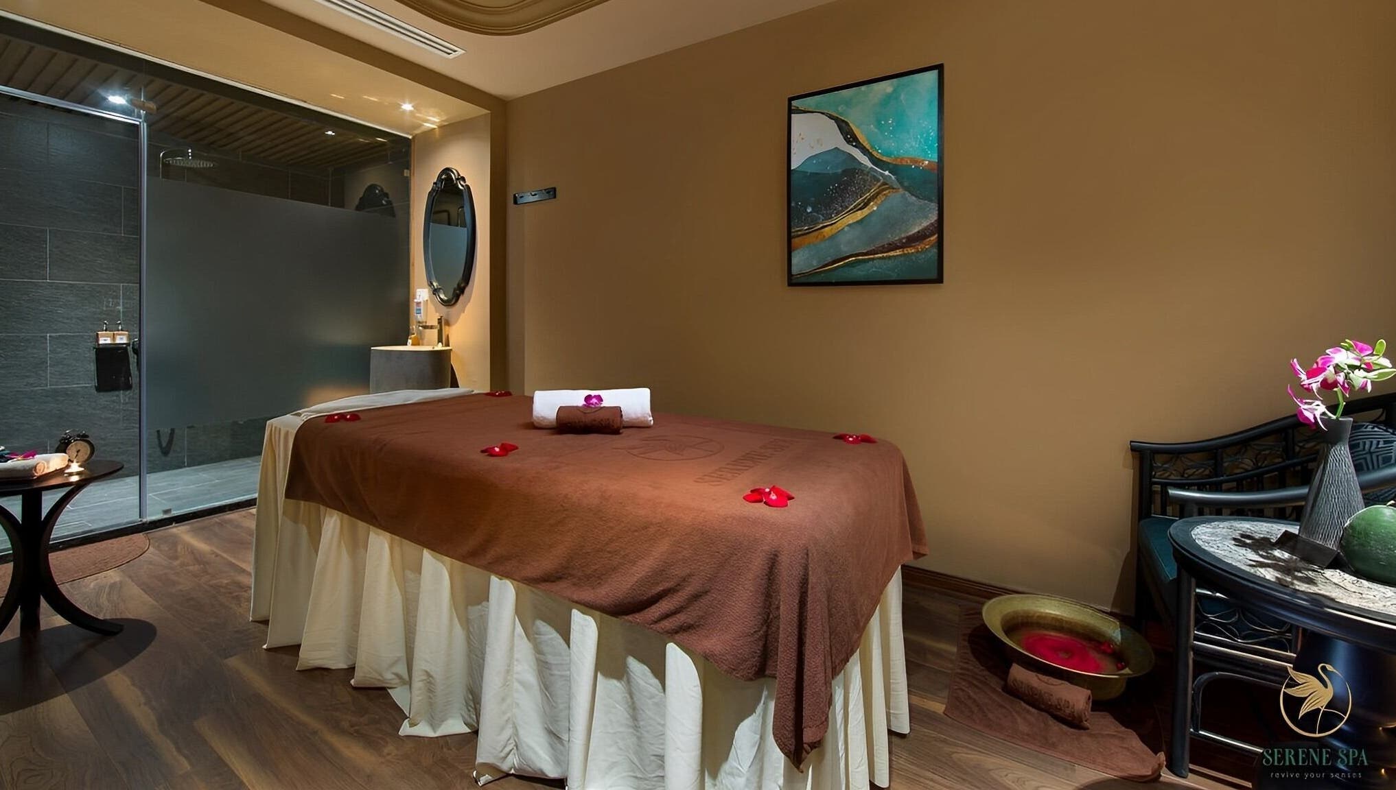 Serene Signature Spa treatment room in Hà Nội, VN, featuring a massage table with floral decorations.