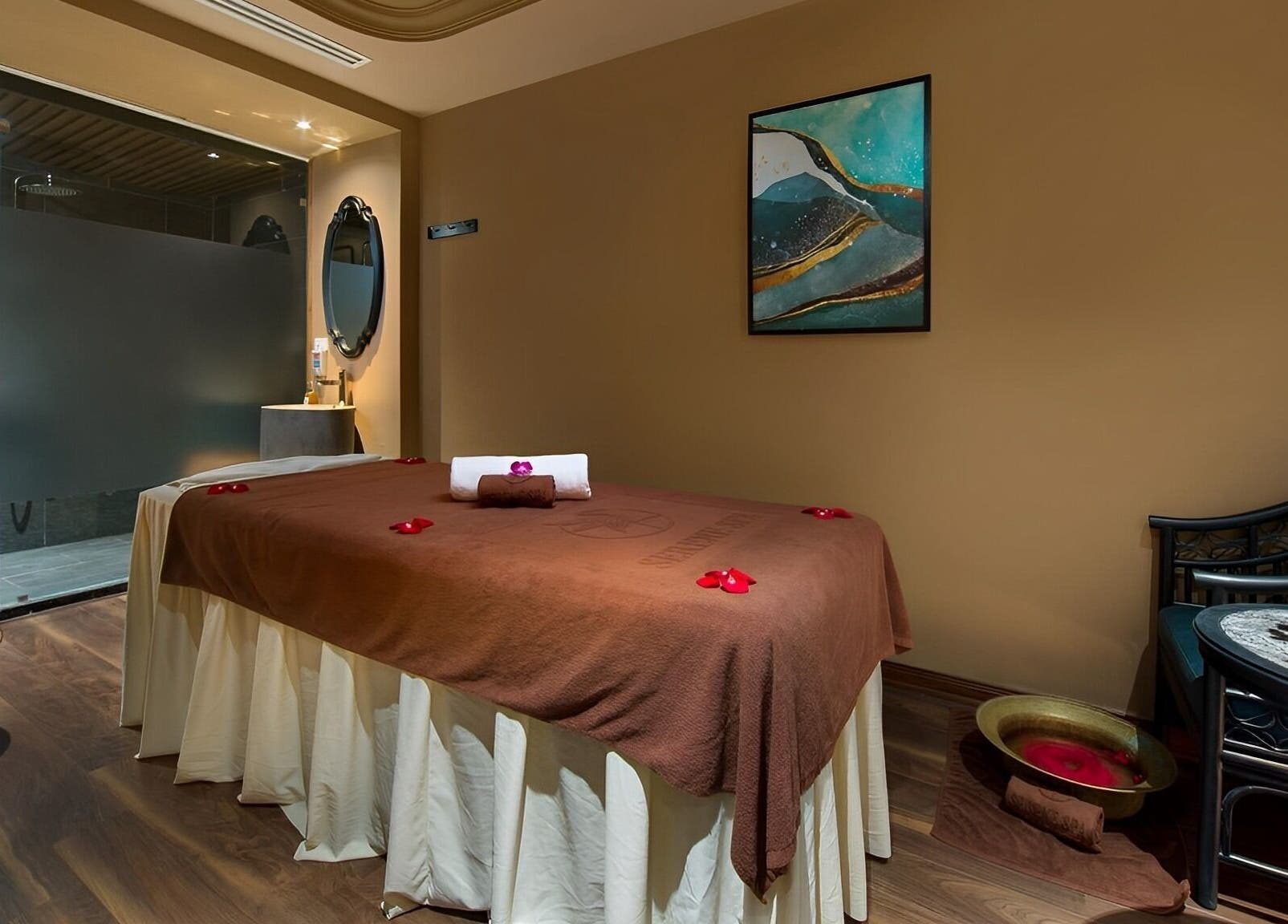Serene Signature Spa treatment room in Hà Nội, VN, featuring a massage table with floral decorations.