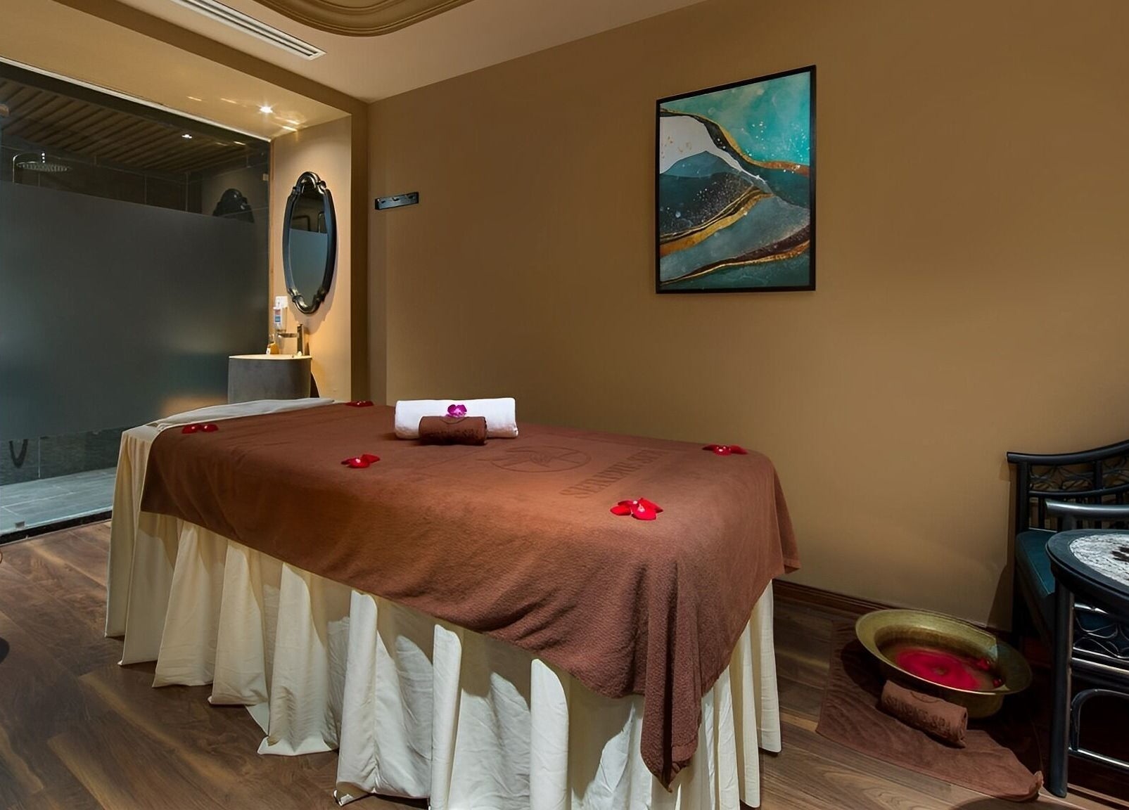 Serene Signature Spa treatment room in Hà Nội, VN, featuring a massage table with floral decorations.