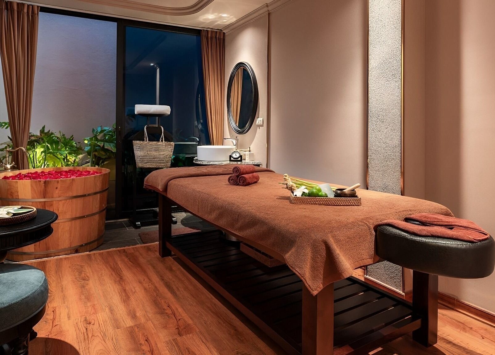 Luxurious treatment room at Serene Signature Spa, Hà Nội, VN, featuring massage table and rose petal tub.